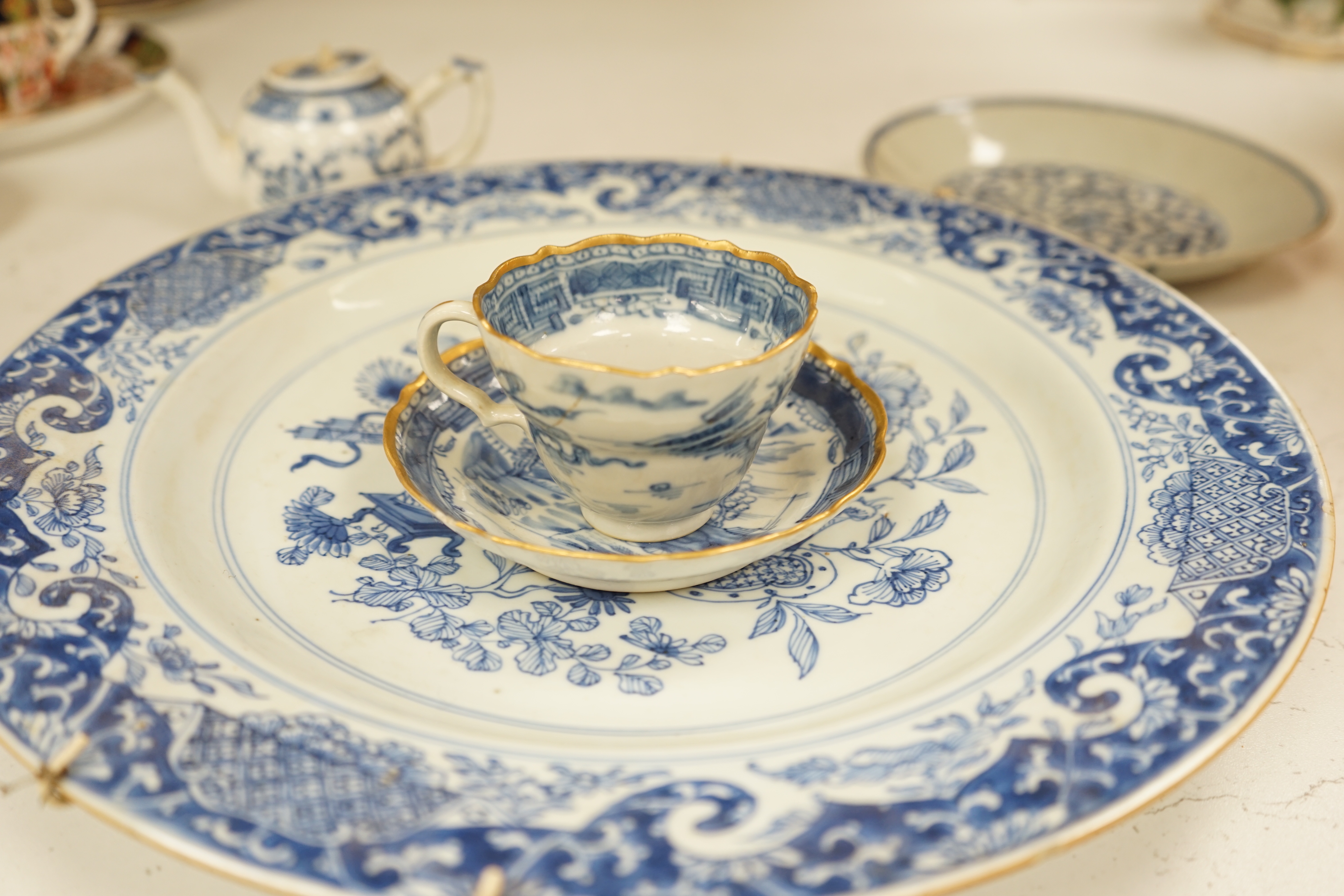 A Worcester teapot, c.1770, two 18th century Chinese porcelain dishes, a cup and saucer, a Chinese shallow bowl and a small teapot, largest dish 39cm